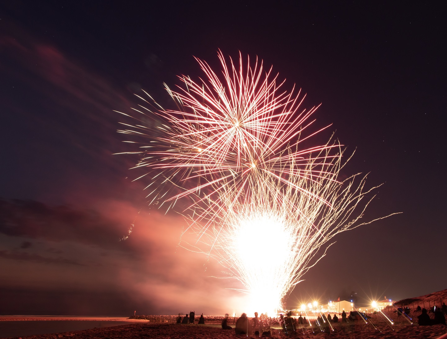 Red fire works with crowd below