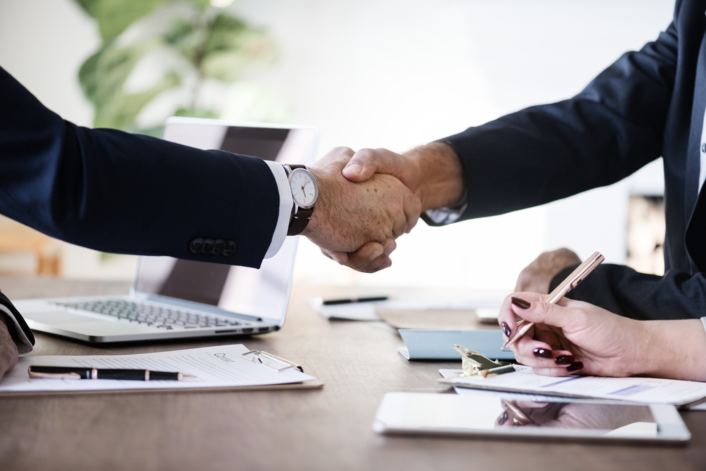 People shaking hands in a boardroom